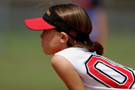 young girl in softball uniform